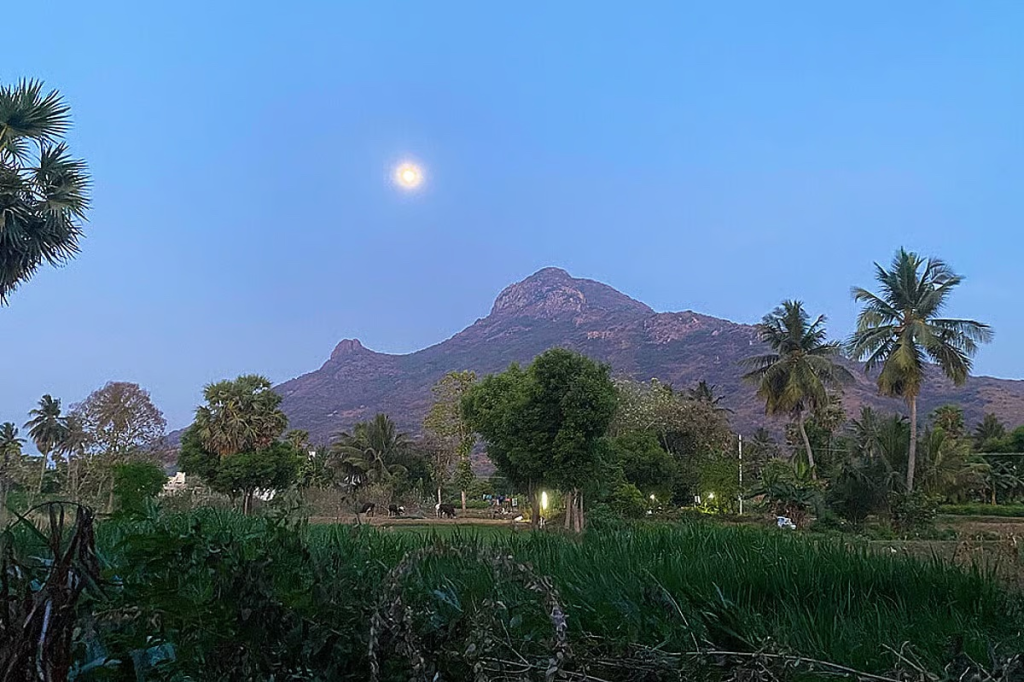 View of a peaceful mountain landscape at sunrise, representing a spiritual retreat setting